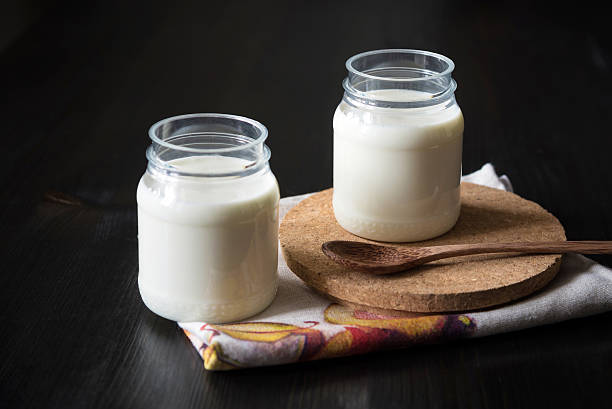 istock natural yogurt in a jar on the dark background 578555940