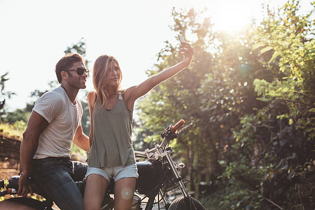 istock Couple taking a selfie on road trip with motorcycle 578556154