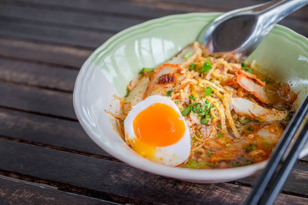 istock Close up Thai noodle with egg on wood table 578556468