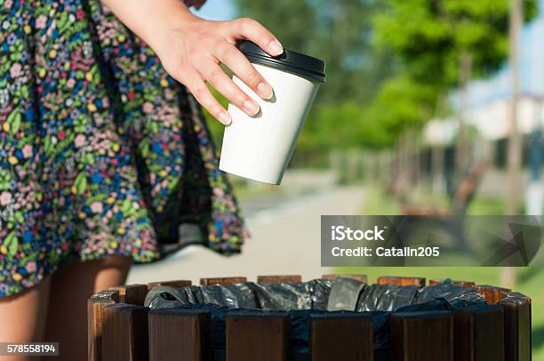Closeup Female Hand Throwing Paper Cup On Trash Stock Photo - Download Image Now - Garbage, Coffee - Drink, Throwing