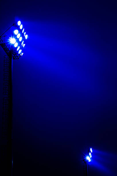 istock Stadium floodlights on a sports field at night 578559802