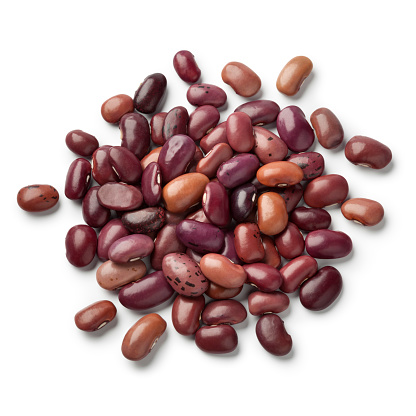 Heap of dried Ayuote Morado beans on white background