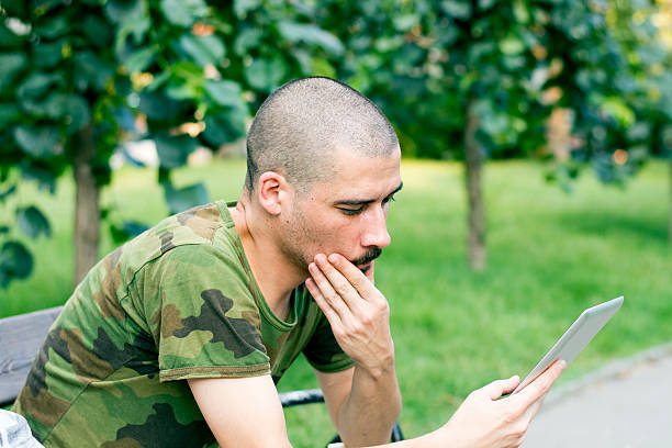 porträt eines jungen mannes mit tablet entspannen im park - hairstyle fashion fashion model retro revival stock-fotos und bilder