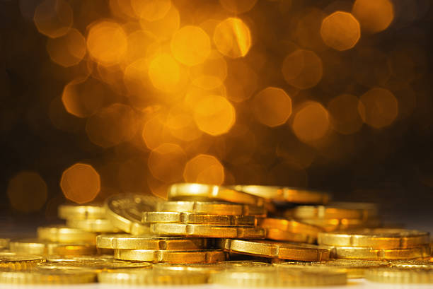 istock Euro coins against yellow defocused lights 578560760