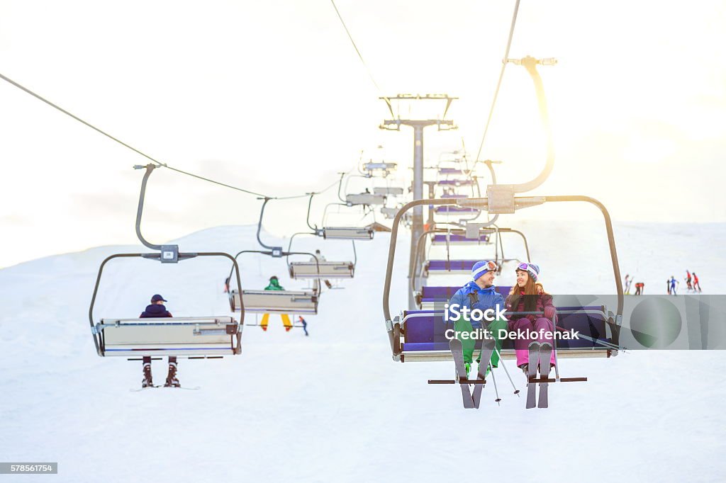 Vacations Young couple on a lift Ski Lift Stock Photo