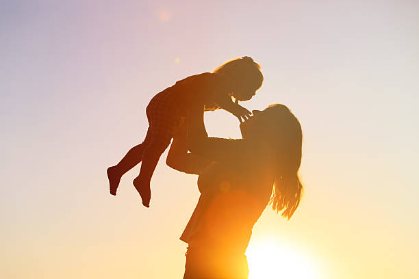 istock mother and little daughter play at sunset 578564482