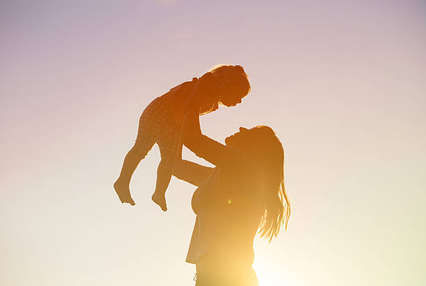 istock mother and little daughter play at sunset 578564530