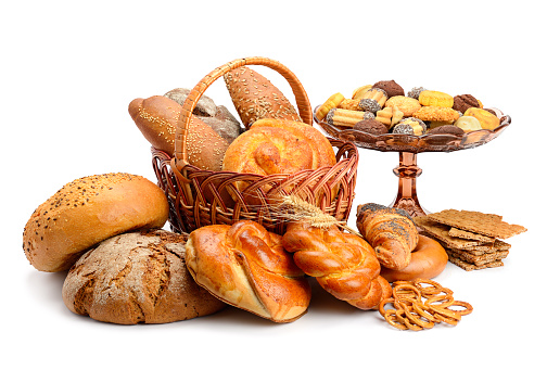 Overhead shot of various kinds of breads on white background.