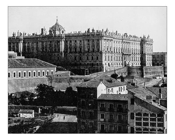 Antique photograph of the Royal Palace of Madrid (Spain)-19th century Antique photograph of the Royal Palace of Madrid (Spain) overlooking the roofs of a Madrid district in a 19th century picture. The 18th century building  is built in a mix of Baroque and Classicism styles. madrid photos stock illustrations