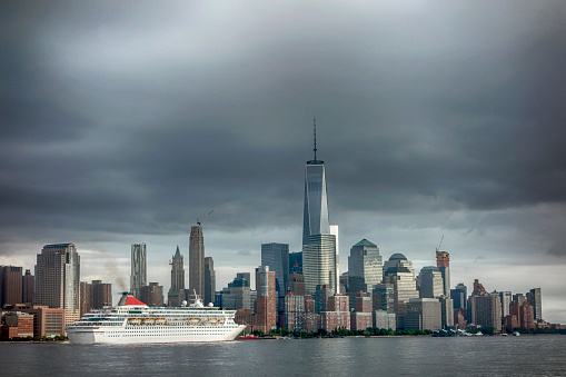 New York City, USA - September 27, 2015: Cruise ship leaving NYC looking to Manhattan from New Jersey shore.