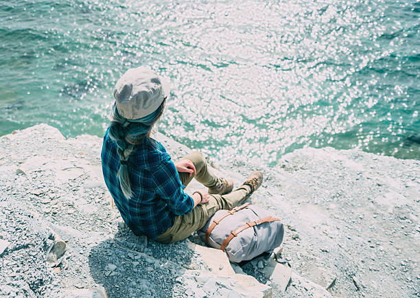 istock Girl sitting on steep coast 578569596