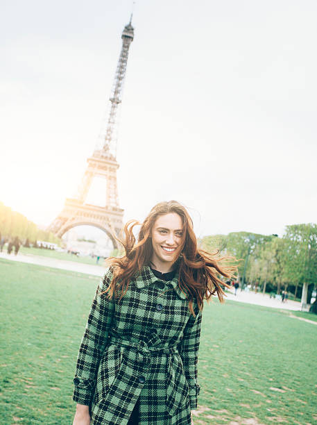 istock Happy young woman posing in front of Eiffel tower 578570194