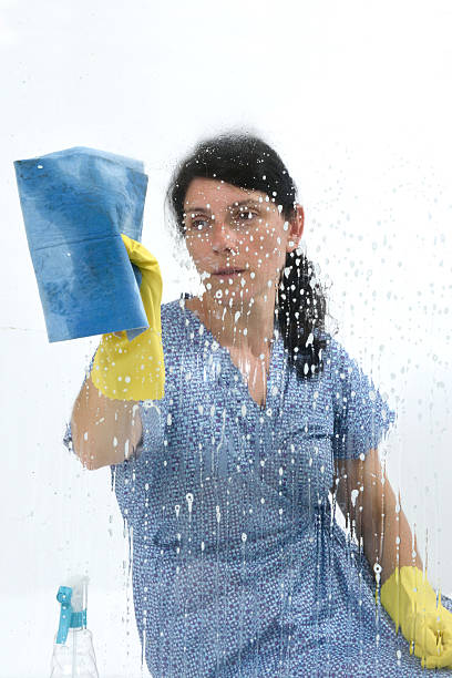 istock woman cleaning glass 578570518