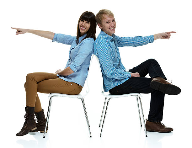 istock Happy couple sitting and pointing 578572406