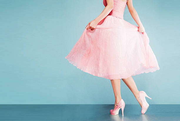 Romantic pink dress with shoes.vintage style. Isolated on blue green background with copy space. pink gown stock pictures, royalty-free photos & images