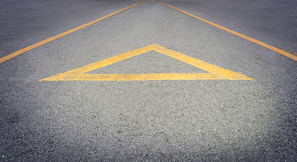 istock Yellow Arrow direction on a rough road with copy space 578573892