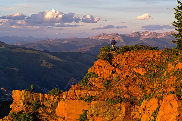 istock Man Hiking Scenic Mountain Canyon Rim at Sunset 578574168