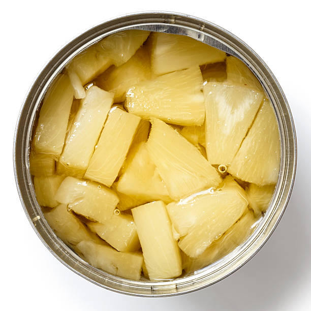 istock Pieces of pineapple in a tin from above. 578575436