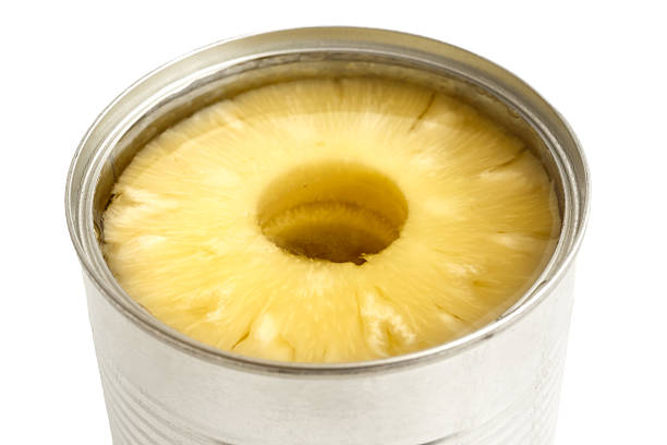 istock Pineapple rings in a tin in perspective on white. 578575642