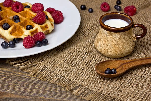 istock waffle with berries on a white plate. milk mug 578576628