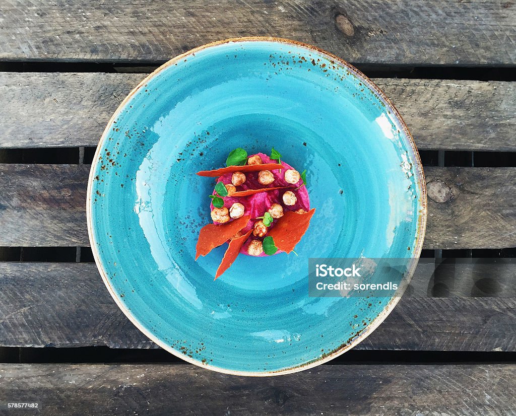 Humus with beet Overhead view of a humus dish Food Stock Photo