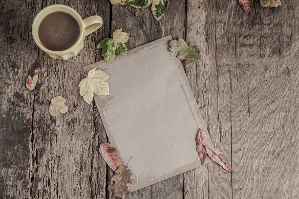 istock coffee and notebook on wooden table decorated with autumn leaves 578578316