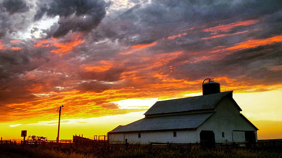 Vibrant colors paint a striking color scheme across the western Iowa sky near this vintage barn. 