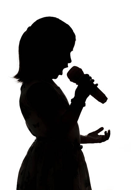 istock Singing yound girl with microphone on white background 578580534
