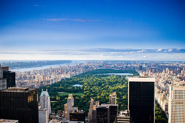 Image of New York Skyline during the day time with bright blue skies and ominous clouds forming above.