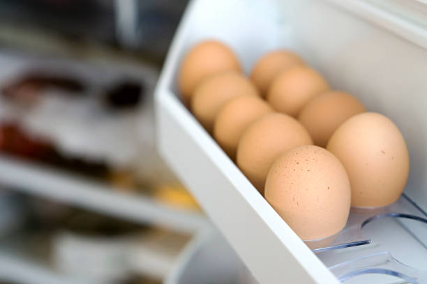 Chicken eggs on a shelf of the refrigerator stock photo
