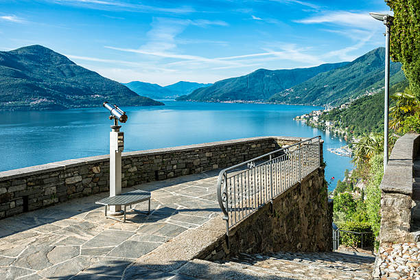 A viewpoint with a telescope at the beautiful lake Lago Maggiore at the border between Switzerland and Italy