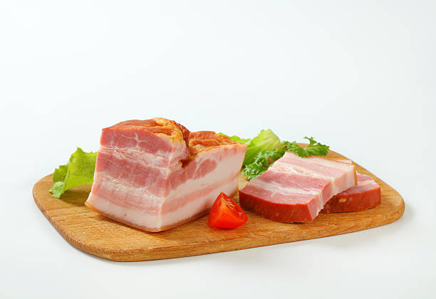Studio shot of sliced Lomo, air dried Spanish pork loin with paprika and garlic cut out against a white background