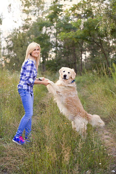 istock Girl walking with a dog 578583678