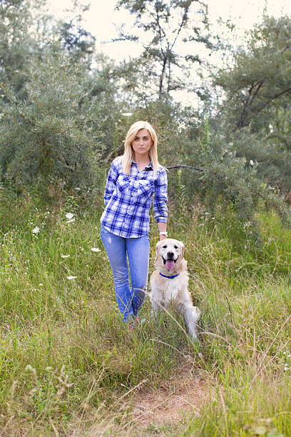 istock Girl walking with a dog 578583880