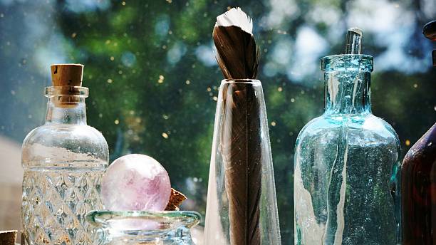 istock Shiny Glass Bottles and a Feather 578586046