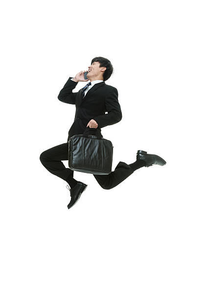 istock Cheerful businessman on phone and jumping 578587070