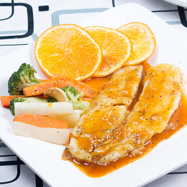 dory fish steak with orange sauce - dory imagens e fotografias de stock