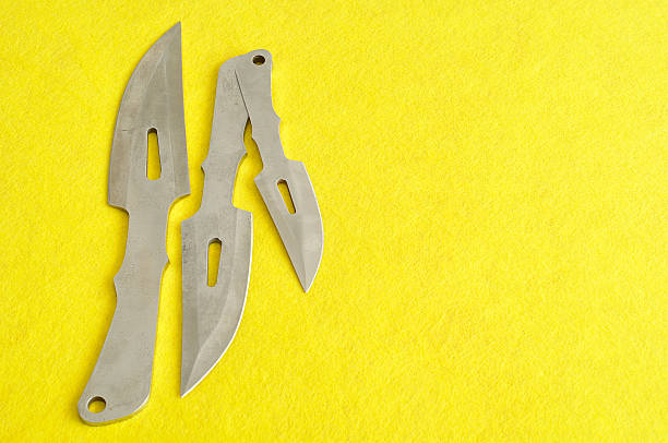 istock Combat knifes on a yellow background 578589340
