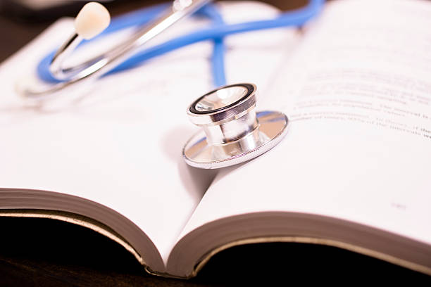 istock Close-up of doctor's stethoscope on desk with books.  Reading, studying. 578589536
