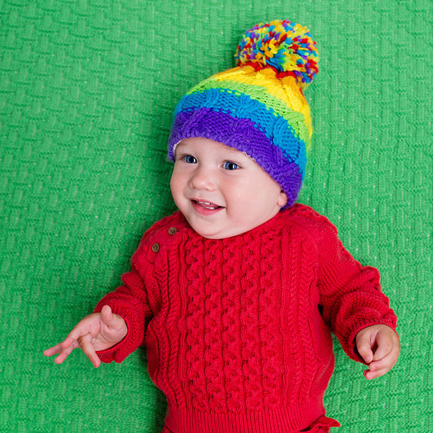 istock Cute baby in warm wool knitted hat on green blanket 578589920