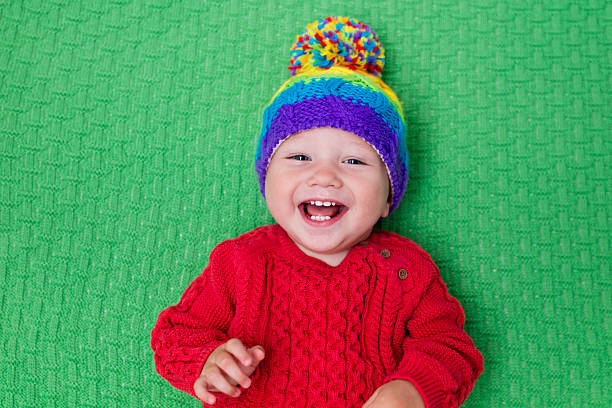 istock Cute baby in warm knitted hat on a green blanket 578590042
