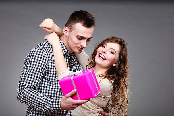 istock happy romantic couple with gift 578591950