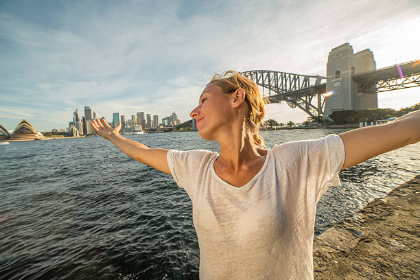 istock Young woman relaxing in Sydney harbour at sunset 578592410