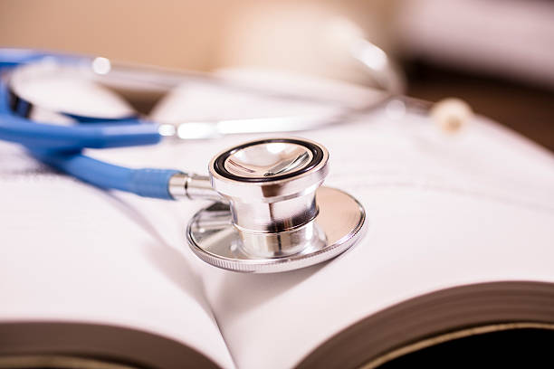 istock Close-up of doctor's stethoscope on desk with books.  Reading, studying. 578593072