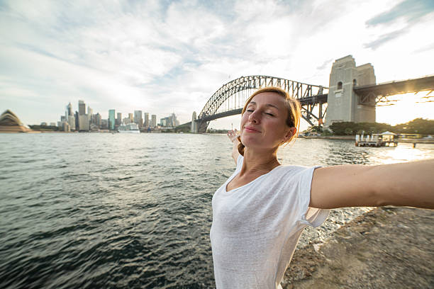 istock Young woman relaxing in Sydney harbour at sunset 578593416