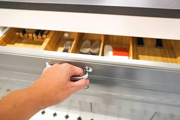 istock Close up of hand opening a grey kitchen drawer 578594506