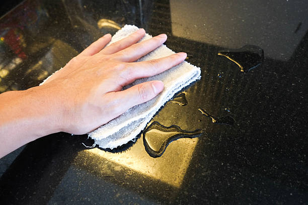 istock Hand wiping black marble stone counter bar 578595122