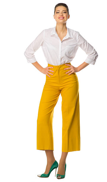 istock Young woman in yellow pants 578596680