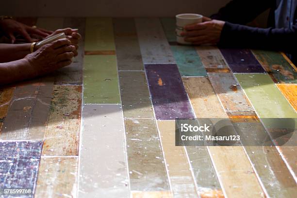 Three Women Sitting At A Soft Pastel Colors Table Stock Photo - Download Image Now - Adult, Adults Only, Cafe Culture