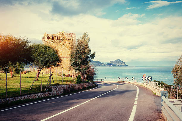istock Asphalt road along the sea at sunset. 578601540